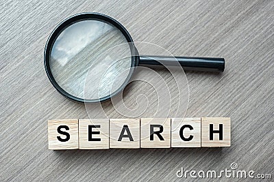 Search text wooden cubes and magnifying glass on wood table background. SEO, Idea, Vision, Strategy, Analysis, Keyword and Content Stock Photo