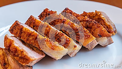 Seared duck breast with crispy skin on a white ceramic plate Stock Photo