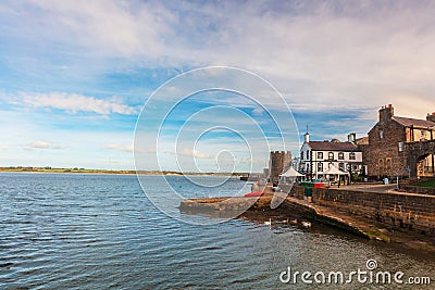 Seascape in Caernarfon with Castle and an old pub by the sea. Editorial Stock Photo