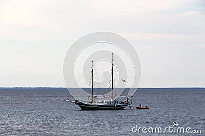 Seascape with a classic sailboat and tender Stock Photo
