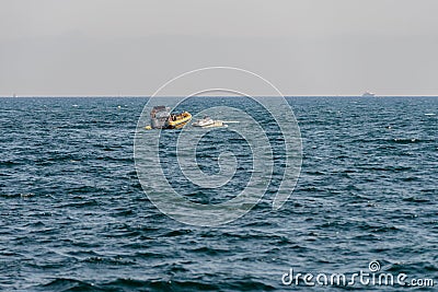 Seascape with a motor boat on the horizon Stock Photo