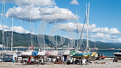 Seascape with mountains and yachts in the foreground of the photo. yachts with masts and sails on the background of the sea Editorial Stock Photo