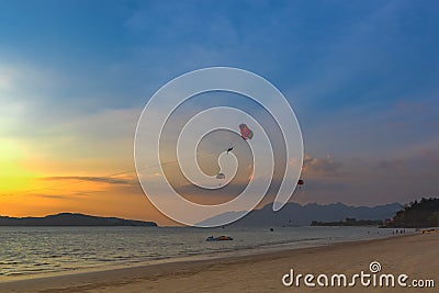 Seascape with parasailing. Sunset on the beach of Langkawi Island, Malaysia Stock Photo