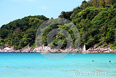 seascape of sailboats and people swimming at phuket le meridian in Thailand. Stock Photo