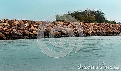 A seascape of the shrine velankanni beach with stone fence. Stock Photo