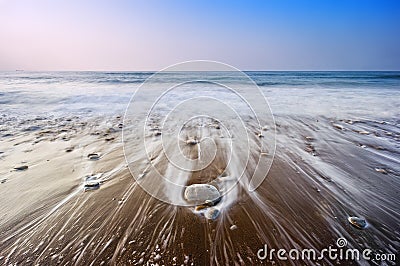 Seascape with wave foam over rocks Stock Photo