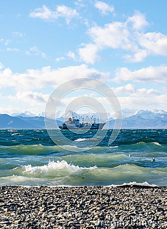 Seascape whith ship on mountains background Stock Photo