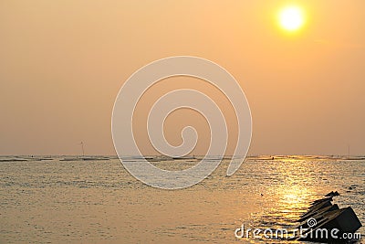 Seascape at Yellow glowing sun settin Stock Photo