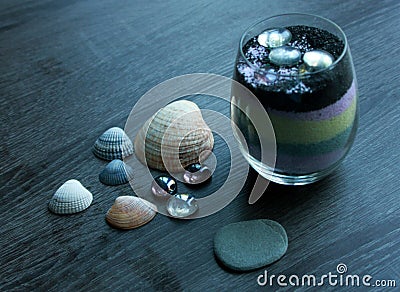 Seashells, glass rocks stones, marbles, and colorful sand decorations Stock Photo