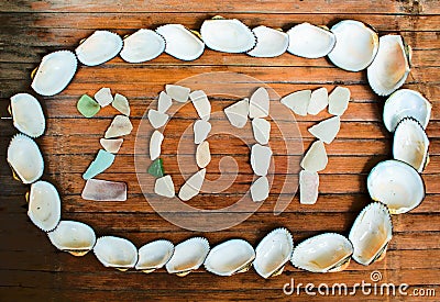 Seashore glass inscription 2017 on wooden background Stock Photo