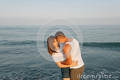 The guy near the sea embraces the girl Stock Photo