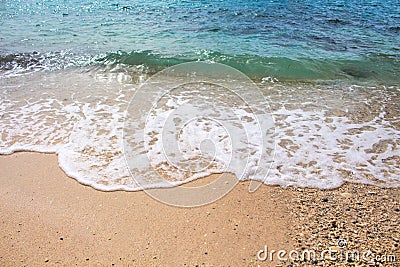 Seashore line with sand beach and sea wave. Turquoise blue tropical sea lagoon for perfect vacation. Stock Photo