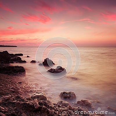 Seashore with misty water at sunset Stock Photo