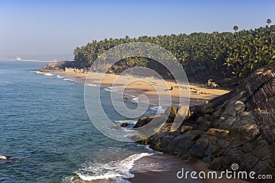 Seashore with stones and palm trees. India. Kerala. Stock Photo