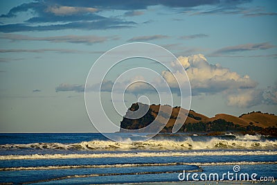 Seashores of New Zealand; beautiful seascape, bright blue ocean, and a small island far away Stock Photo