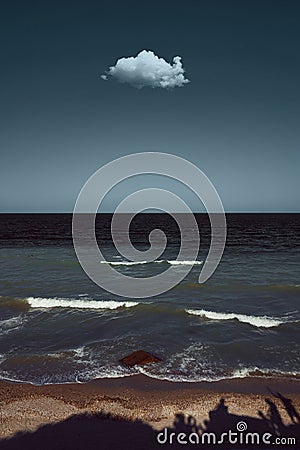 Seaside image with a singular cloud above Stock Photo