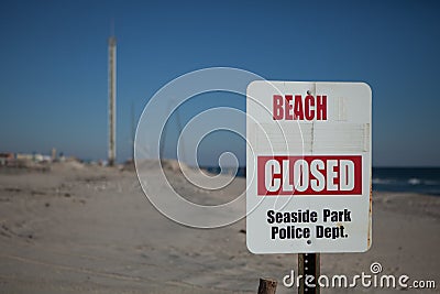 Seaside Park, NJ - Nov 10, 2013 - Beach closed sign with Funtown pier in the distance devistated from Hurricane Sandy and a later Editorial Stock Photo