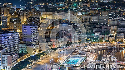 Seaside swimming pool in Monaco night timelapse, buildings in the background. Editorial Stock Photo