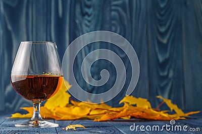 Seasonal alcohol drinking on blue table with leaves Stock Photo