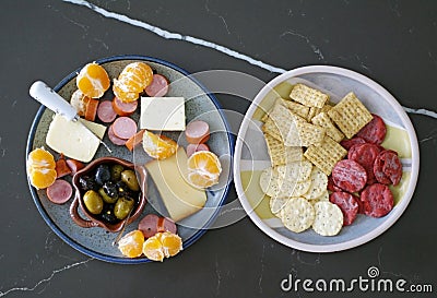 Seasonal appetizer platter with olives, cheese, meat and oranges Stock Photo