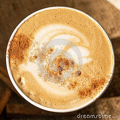 Seasonal warm cinnamon pumpkin spice Latte in eco-cup, top view, close-up Stock Photo
