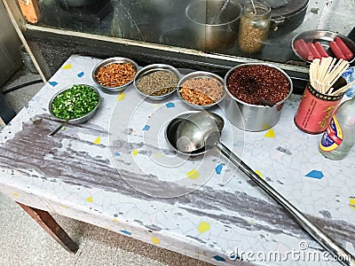 Seasonings, spices and toppings on kitchen table Editorial Stock Photo