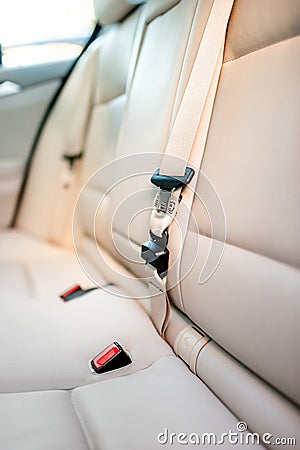 Seat belt on rear seat of modern car with beige leather interior Stock Photo