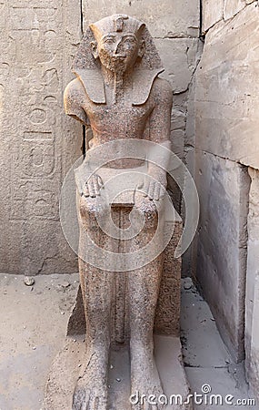 Seated Statue of Pharaoh Thutmose III near the Festival Hall of Thutmose III at The Karnak Temple Complex in Luxor, comprises a Stock Photo