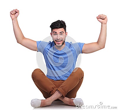 Seated young man is winning Stock Photo