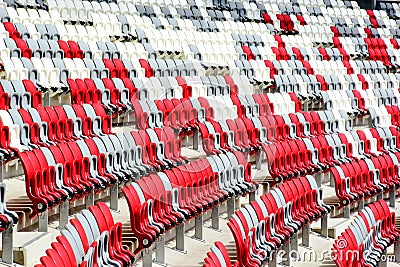 sport stadium seats in perspectivel view. curving rows of colorful plastic seats on steel frame. Stock Photo