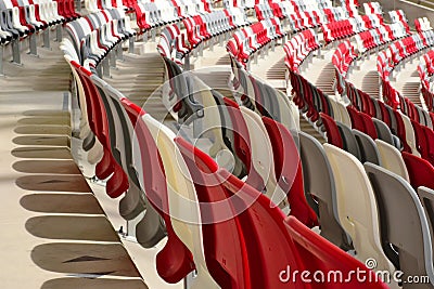 seating area detail of sport Stadium. curving rows of colorful plastic seats on steel frame. Stock Photo