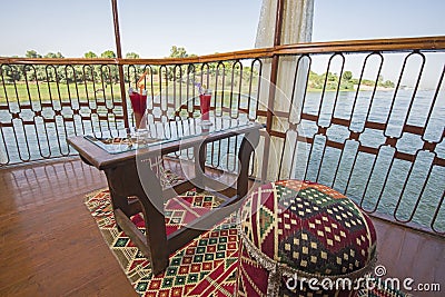 Seating on the balcony of a luxury river cruise boat with cocktails Stock Photo