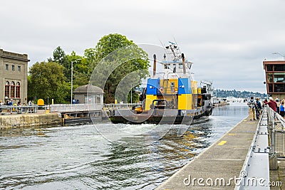 Ocean going tug boat Pacific Titan returns though Ballard Locks in Seattle Editorial Stock Photo