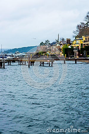 Seattle Beach Dock Puget Sound Washington State Harbor Boat Yellow Apartment Blue Water Rocks Trees Evergreen Beautiful Bay Landsc Stock Photo