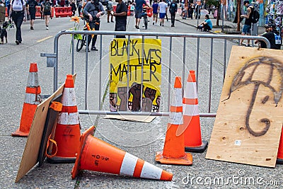 Seattle, WA - 11 June 2020. Black Lives Matter sign held at protest on streets and buildings Editorial Stock Photo