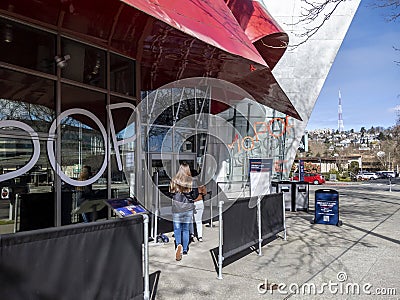 Seattle, WA USA - circa March 2022: Family with a baby stroller entering the Museum of Pop Culture on a bright, sunny day Editorial Stock Photo