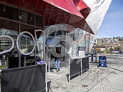 Seattle, WA USA - circa March 2022: Family with a baby stroller entering the Museum of Pop Culture on a bright, sunny day Editorial Stock Photo