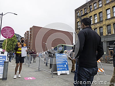 Seattle, WA USA - circa May 2021: An Indian man entering the line at a covid vaccine center at Lumen Field in downtown Seattle Editorial Stock Photo