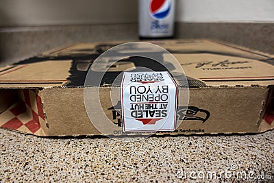 Seattle, WA USA - circa October 2021: Macro, selective focus on a Pizza Hut pizza box sitting on a kitchen counter after being Editorial Stock Photo