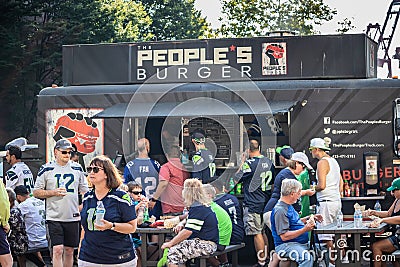 Seattle, Washington - 8/9/2018 : Seahawks fans grabbing a bite to eat at Peoples Burger before a game at Centurylink Field Editorial Stock Photo