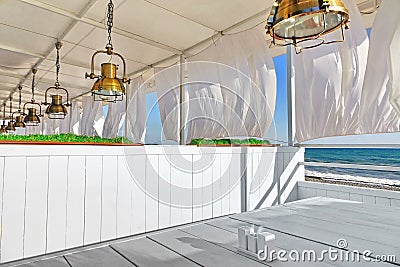 Seaview Restaurant Interior. White Terrace With Wooden Furniture Stock Photo