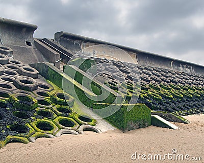 The seawall south of blackpool constructed of concrete honeycomb type structures with steps leading to the beach Stock Photo