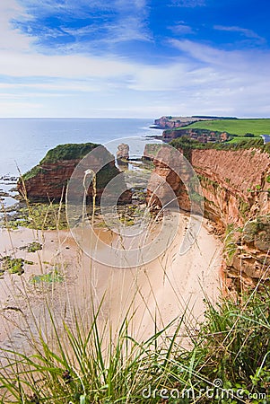 Secluded beach by ocean Stock Photo