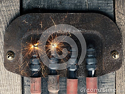 Second Advent background with four spark plugs on rusty sign, car workshop advent Stock Photo