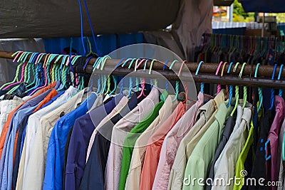 Second hand shirts for sale in flea market Stock Photo