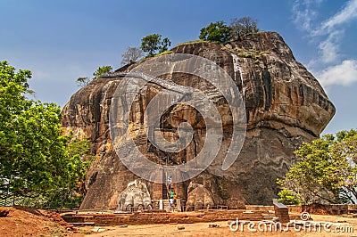 The second level stairs and entrance to the former fortress and monastery of Sigiriya rock, guarded by a pair of lion feet in Sri Stock Photo