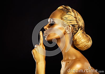 Secrecy. Bodyart. Golden Woman showing Silence Sign. Hush! Stock Photo