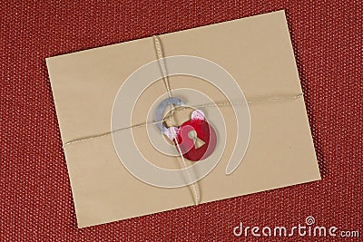 A secret envelope, a parcel bound with a rope, with symbolic lock. Open the lock. Stock Photo