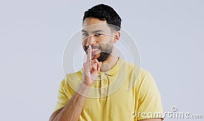 Secret, happy man and portrait in studio for sign of privacy, surprise sales and confidential deal on white background Stock Photo