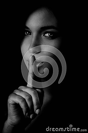 Secret - mystery woman with finger at lips Stock Photo